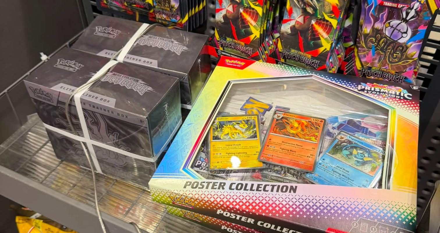 Shelf photo: Prismatic Evolutions Poster Collection + Mega Evolution: Pitch Black ETBs/booste at Lowe's